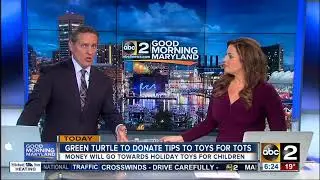 Green Turtle employees giving their tips to Tots