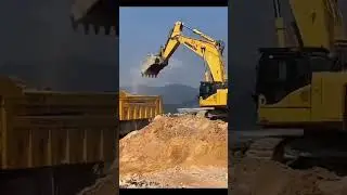PC1250 Slams Rock Loudly -Dump Truck Waiting