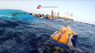 Migrants rescued by Italian coastguard after an overcrowded boat capsized