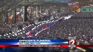 Mayor eulogizes officer as cops outside turn backs