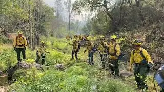Crews cut  a fire line on Hennessey fire in Lake County