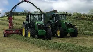 John Deere 6195M lifting grass with a JF harvester