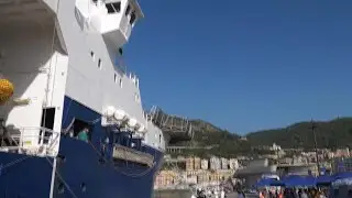 Rescued refugees disembark in an Italian port after a perilous sea crossing