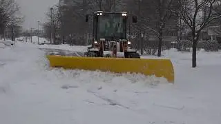 Arctic Sectional Plow Clearing Front Drive