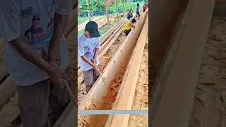 Villagers Craft a Long Dugout Canoe from a Single Tree Trunk.