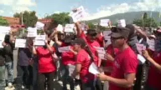 Dozens of police officers and prison guards took to the streets of San Salvador on Tuesday to demand