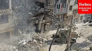 Crews Work To Clear Debris From Residential Building In Tehran Following Israeli Strikes
