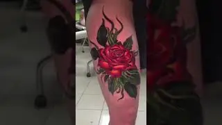 Rose flower tattoo on a woman's thigh