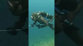 Spectre Frogman In Vintage Scuba firing Speargun wearing Beavertail Smooth skin Wetsuit