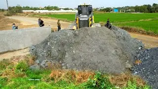 New project landfill by wheel 10 Dump truck unloading rock and Heavy bulldozer pushing rock fill