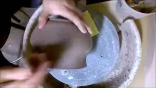 carving fleur de  lis into a planter