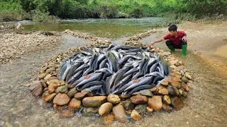The boy skillfully arranged the stones in the stream together to create a unique fish trap.