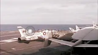 08/05/1965 Men work on control panel in engine room as RF8A Crusader taxi over deck of USS Coral Sea