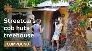 Family compound of streetcars, cob huts, treehouse & barrel