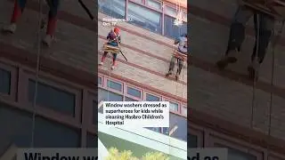 Window washers dressed as superheroes for kids while cleaning Hasbro Children's Hospital