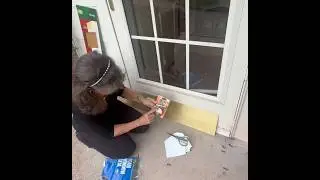 Storm door repair by installing a weatherproof seal  and a brass plate to cover the damage.