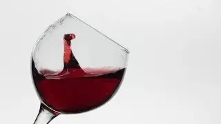 Close Up of a Drop Falling in Glass with Red Wine. Rose Wine on White Background | Stock Footage -