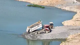 Good job!! The truck is paving the road and the D31 bulldozer is pushing it.