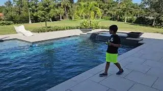 Ollie's Adventures - Ollie drives remote control Boat in pool
