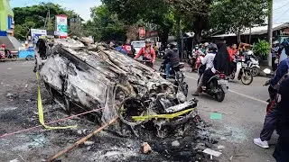 Indonesia  police trucks damaged after football riot kills 129 people