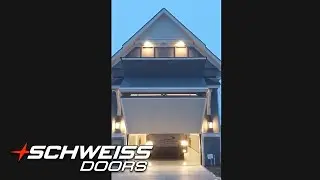 Home with Hidden RV Port and a Schweiss Bifold Garage Door at night
