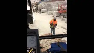 Mobile crane apprentice attempting to fix a grease gun
