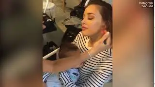 Bec Judd gets her makeup done while holding son Tom before filming