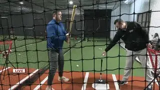 Keith Kaiser takes a swing at baseball at The Bat Cave