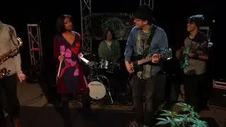 News Anchor Cowbells Her Way Onstage During A Cosmic Knot Performance.