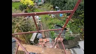 timber frame job, lime render panel, top of scaffold, garden view