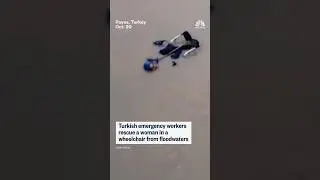 Turkish emergency workers rescue a woman in a wheelchair from floodwaters