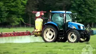 T6080 spraying a grass paddock