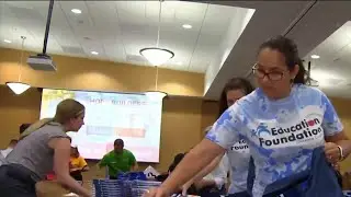 Volunteers help prepare thousands of backpacks for back-to-school event