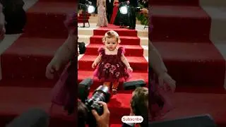 A little cute baby on a glamorous red carpet