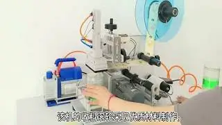 Semi automatic labeling machine for flat bottles