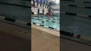 Very windy and cold weather, little girl came to her swimming team to practice