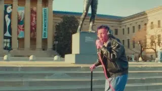 Handicapped man Raps While climbing rocky steps .