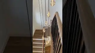 Subtle dance between railing and lighting #interiordesign #entry #chandelier #stairs