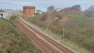 A train from Euston  comes past before the Water Cannon departs Holyhead. 