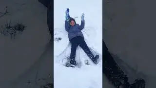 Akira is making snow angels. UK winter 2022.(1)