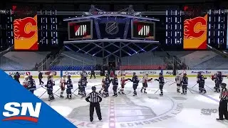 Calgary Flames And Winnipeg Jets Bump Fists After Finishing Their Series In Four Games