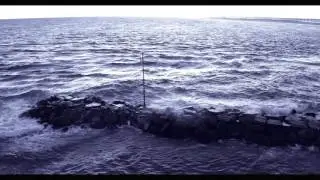 Waves crashing against jetty at  and rolling ashore at Shinnecock Inlet, Long Island, NY
