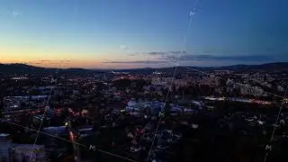 urban dusk with vibrant lights, nighttime cityscape featuring illuminated rooftops and city streets