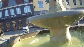 Tony the Traveller by large fountain in Roskilde City Centre