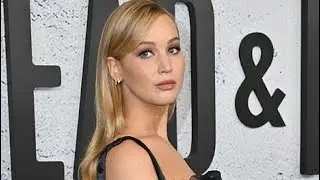 Pregnant Jennifer Lawrence cradles baby bump at LA film premiere