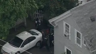 2 men placed in police custody after armed standoff near home in Mass. city