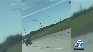 Video shows debris falling onto highway after 2 aircraft crash mid-air during Dallas WWII airshow