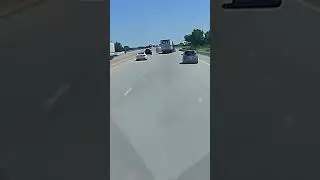 Semi-truck driver survives crash off overpass and explosion; driver of car flees scene