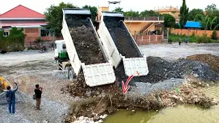 Huge project using Heavy dump truck unloading stone with Heavy Bulldozer working push stone filling 