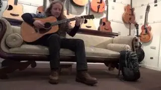 MIke McMann test driving a guitar at Mandolin Brothers